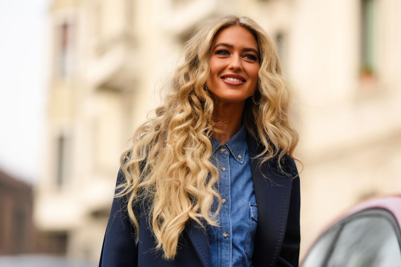 Emili Sindlev's natural curls are a beauty street style trend during Milan Fashion Week Womenswear F...