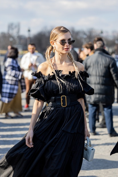Braided ponytails are a Paris Fashion Week Fall/Winter 2023 street style beauty trend.