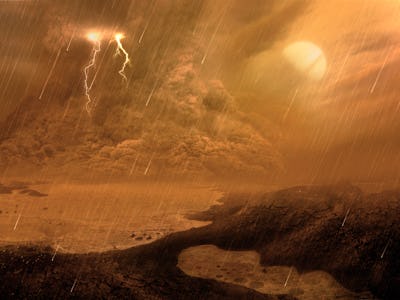 Dust storm of the surface of Titan, illustration. Titan, the largest moon of Saturn, is the only bod...