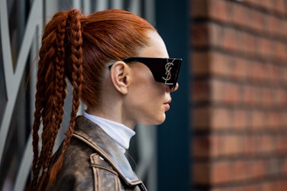 Braided ponytails are a Paris Fashion Week Fall/Winter 2023 street style beauty trend.
