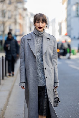 Brunette bangs are a Paris Fashion Week Fall/Winter 2023 street style beauty trend.