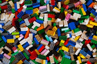 A colorful photo of a big pile of colorful Lego bricks. Recently, six scientists swallowed Lego head...