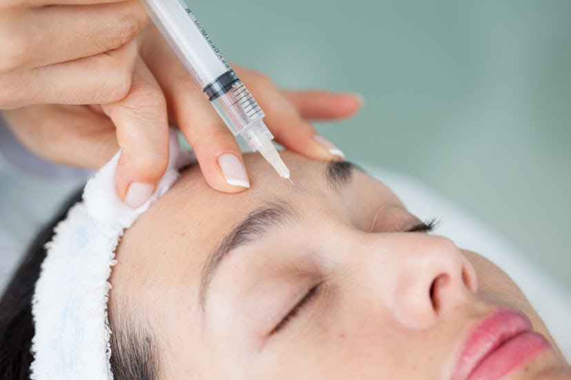 A woman getting Botox on her eleven lines