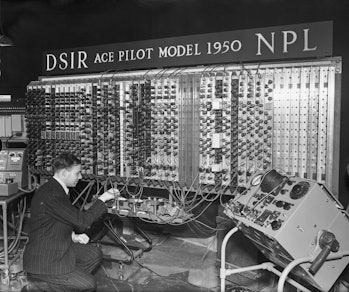 Electronic engineer Edward Newman inspects the mercury delay lines, which form the memory of Pilot M...