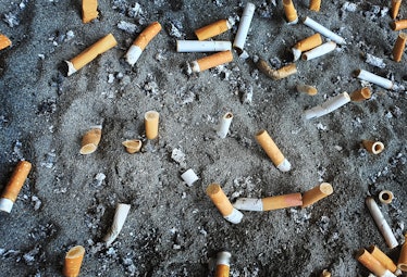 Cigarettes in public bin with ashtray