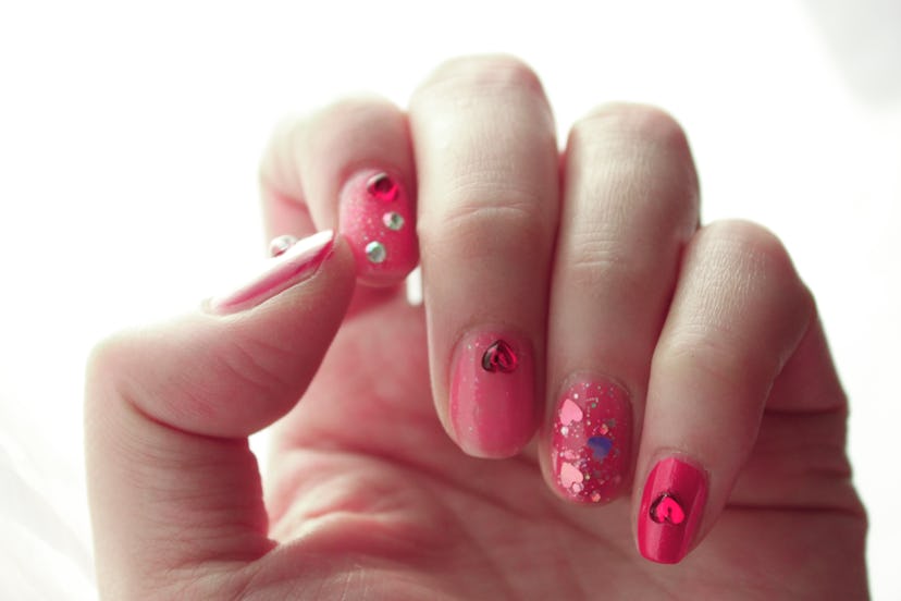 Woman pink nail with lots of hearts for valentine's day