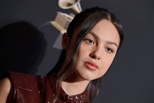 Olivia Rodrigo attends the Pre-GRAMMY Gala in a butt-slit burgundy dress