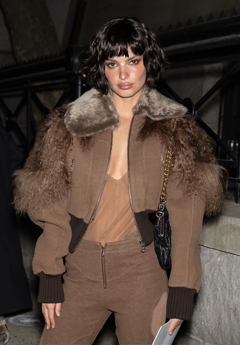 Emily Ratajkowski is seen arriving to Marc Jacobs Runway Show 2023 in a see-through top and fur coat