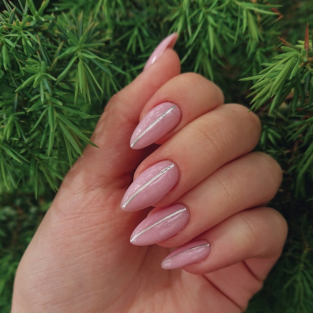 pretty pink nails for valentine's day with metallic stripe down the middle