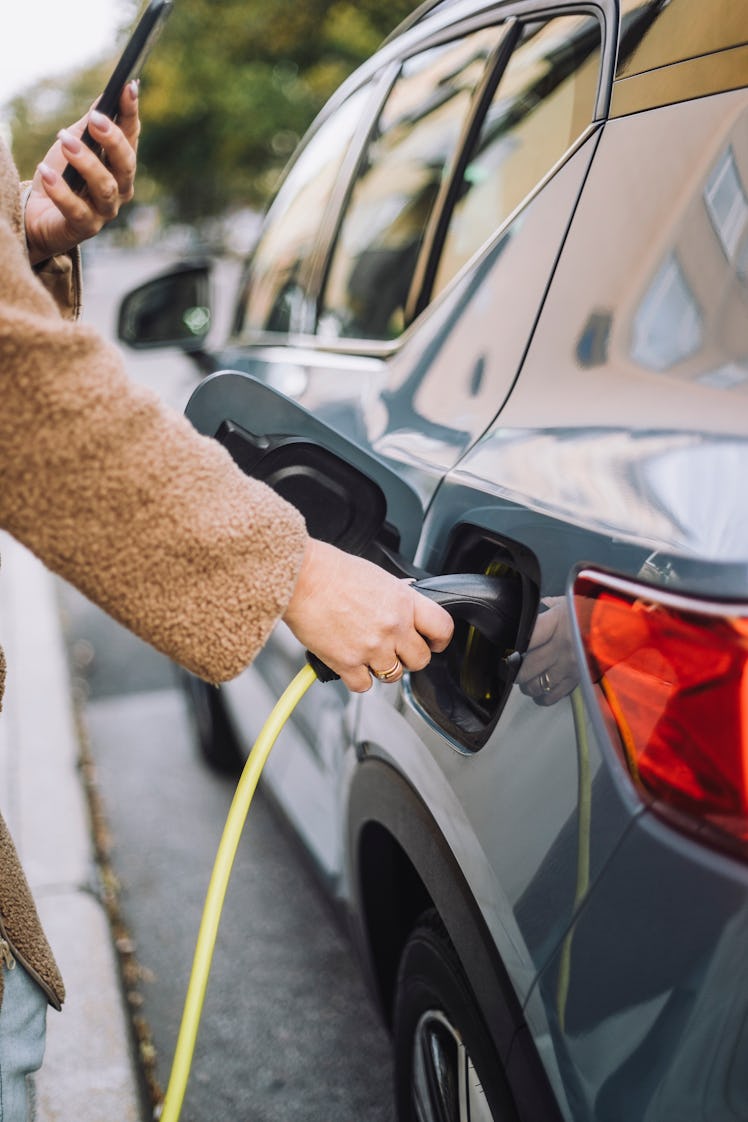 A person charging their electric vehicle.