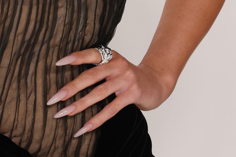 Kylie Jenner wore long, nude, stiletto lip gloss nails at the 2022 CFDA Awards.