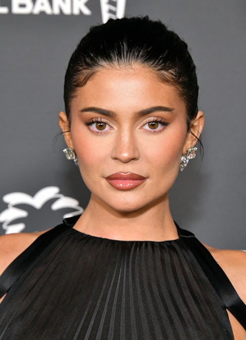 Kylie Jenner photographed at Baby2Baby event with her hair slicked back.