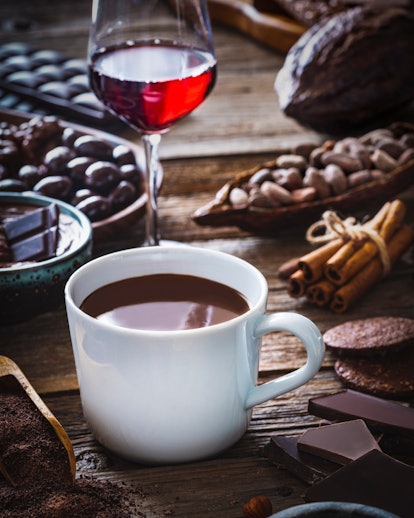 Melted Hot Chocolate and red wine wineglass with cocoa powder
