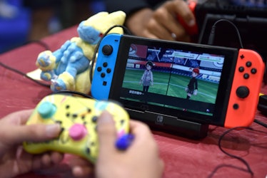 LONDON, ENGLAND - AUGUST 18: A competitor plays Pokemon on a Nintendo Switch console during the 2022...