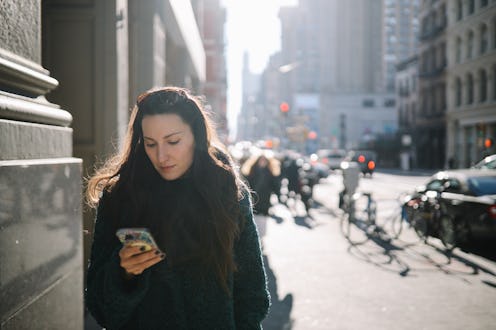 Woman in her 30s commuting through the streets of Manhattan, New York City. She is wearing a fake fu...