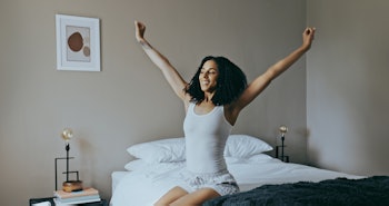Wake up, black woman and stretching in bedroom, rest after sleeping and ready to start the new day. ...