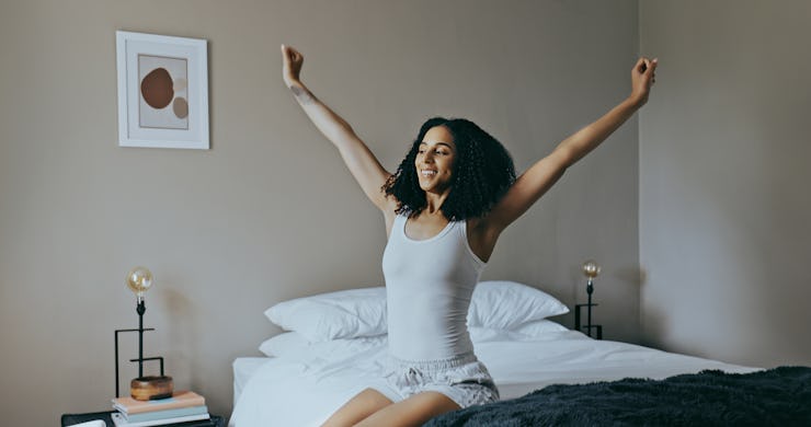 Wake up, black woman and stretching in bedroom, rest after sleeping and ready to start the new day. ...