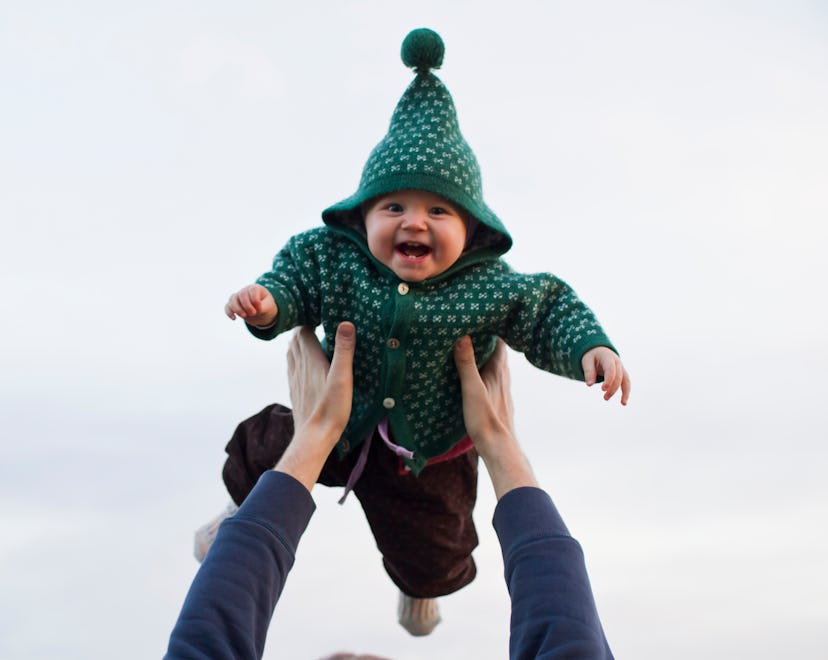 a cute baby in a green hoodie in a list of St. Patrick's Day names