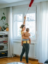 Young mom cleaning windows; A woman in Spain made history when courts ordered for her ex-husband to ...