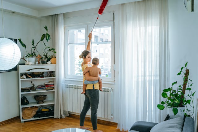 Young mom cleaning windows; A woman in Spain made history when courts ordered for her ex-husband to ...