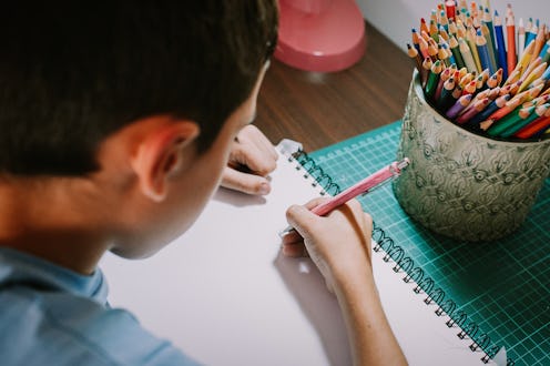 boy drawing in notebook