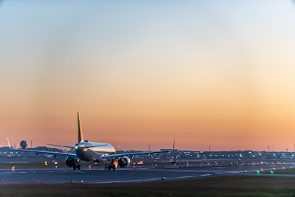 An airplane of Air Portugal taxiing on runway in Pearson International airport at dusk, Toronto,Cana...