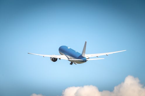 This is a photo of a passenger aircraft after take off flying towards the clouds