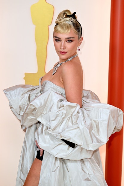 Florence Pugh's 2023 Oscars hair was a creative ponytail that turned into micro bangs.