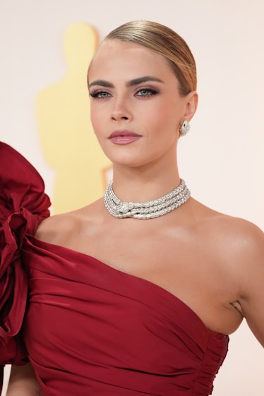 HOLLYWOOD, CALIFORNIA - MARCH 12: Cara Delevingne attends the 95th Annual Academy Awards on March 12...