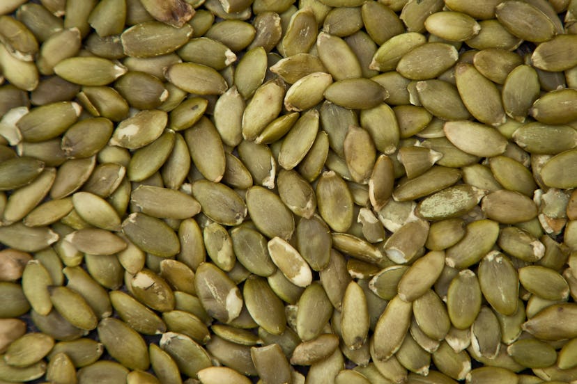Close-up, full frame view of a large group of pumpkin seeds, also known as pepitas.