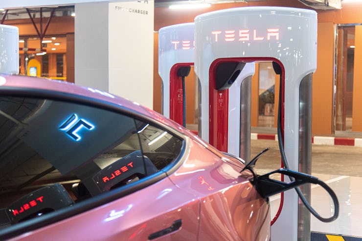 BANGKOK, THAILAND - 2023/02/16: A Tesla car is seen plugged into a Tesla Supercharger at Central Wor...