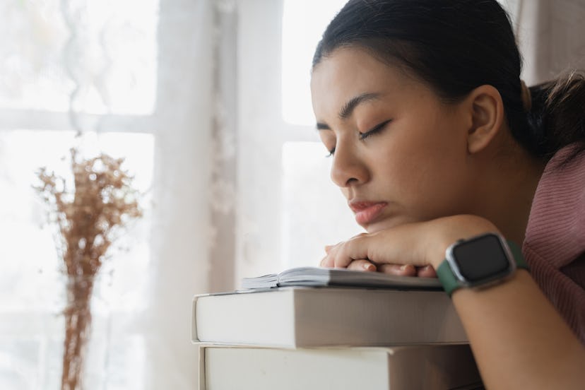 Tired woman at the book in office