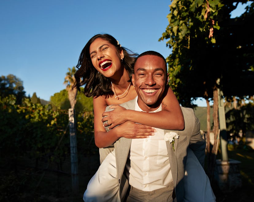 Happy couple laughing in a list of April Fools' pranks to play on your wife