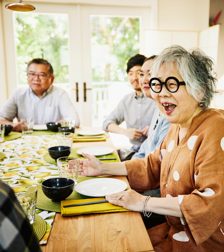 Laughing grandmother seated at dining room in an article about April Fools' Day pranks