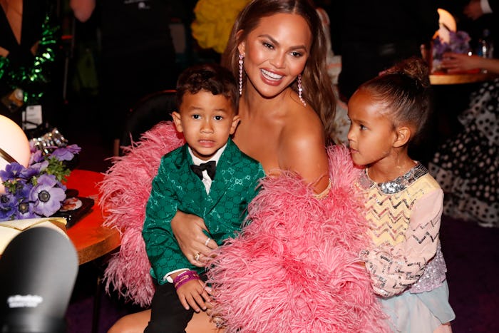 Chrissy Teigen has a little helper in the house.