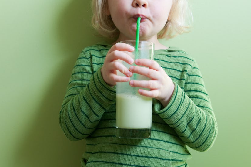 preschool kid drinking green milk in an article about leprechaun pranks