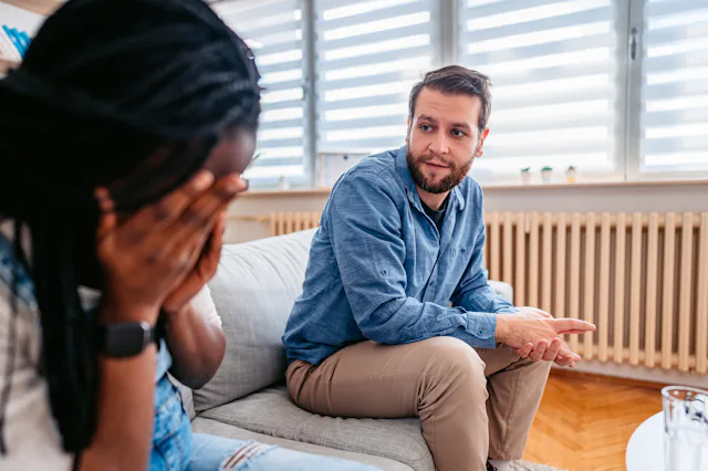 Young pregnant couple arguing on the sofa in the living room. A dad-to-be posted on Reddit after he ...
