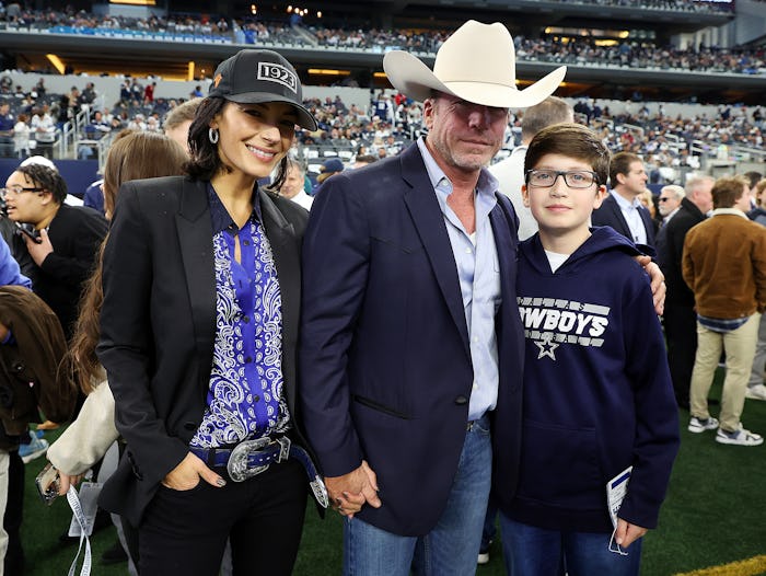 Nicole Muirbrook and Taylor Sheridan are seen withe their son Gus on the sidelines before the game b...