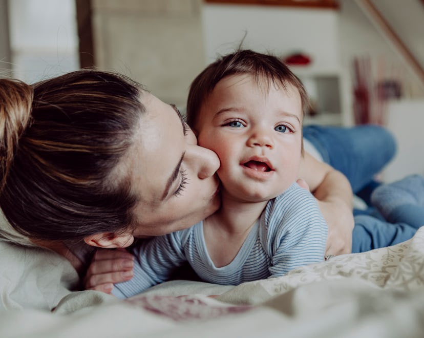 Mom kisses baby boy's cheek in a story full of quotes about having sons.