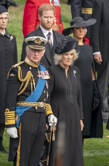 King Charles III, the Duke of Sussex, the Queen Consort, and the Duchess of Sussex look on as the St...
