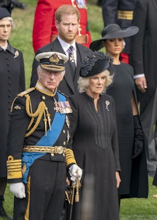 King Charles III, the Duke of Sussex, the Queen Consort, and the Duchess of Sussex look on as the St...