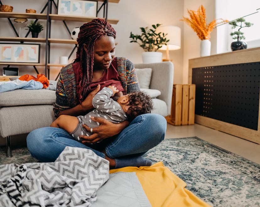 Mother breastfeeding her baby at home, in an article about how to stop breastfeeding