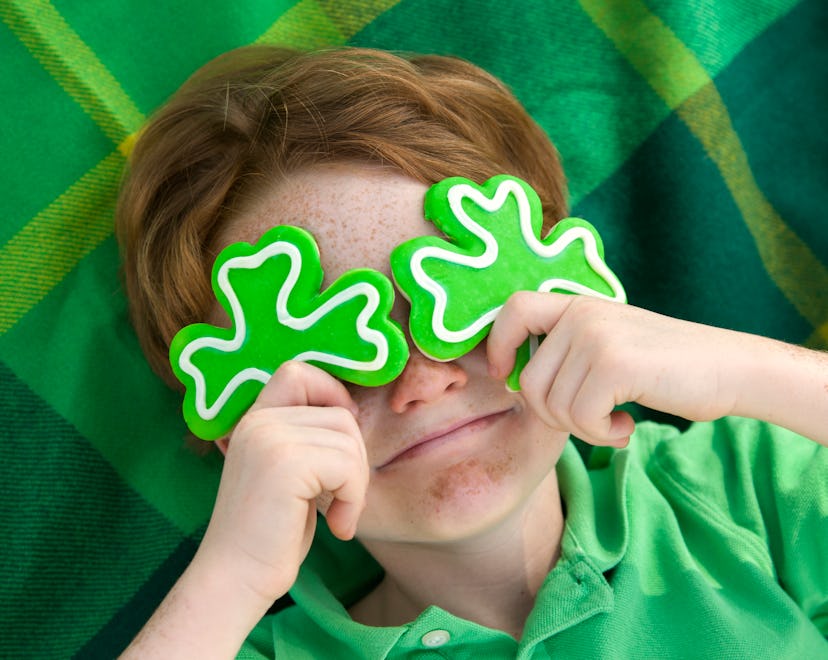Redhead and freckle face Irish boy leprechaun in a list of St. patrick's Day caption ideas.