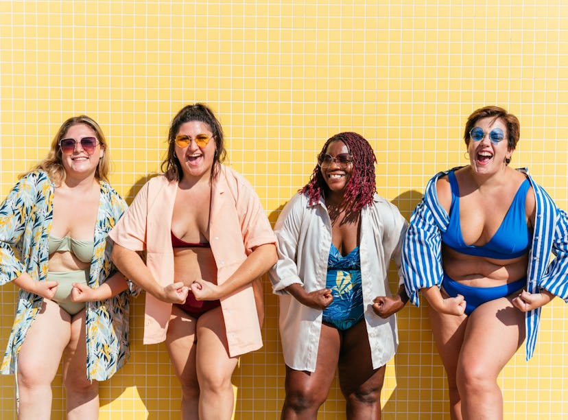 four women pose in bathing suits and strike a pose as they consider how the April 2023 full Pink Moo...