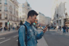 A man uses Google Maps in a city. Maybe he is contributing to his cognitive decline!