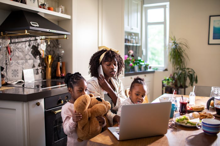 Close up of a single mother having breakfast with her two young daughters