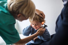 Doctor looks in toddlers ears in a story answering the question, how does behavior change after ear ...