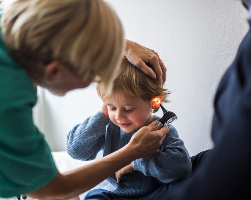 Doctor looks in toddlers ears in a story answering the question, how does behavior change after ear ...