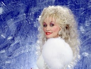 American singer-songwriter, actress, and businesswoman Dolly Parton, poses for a studio portrait cir...