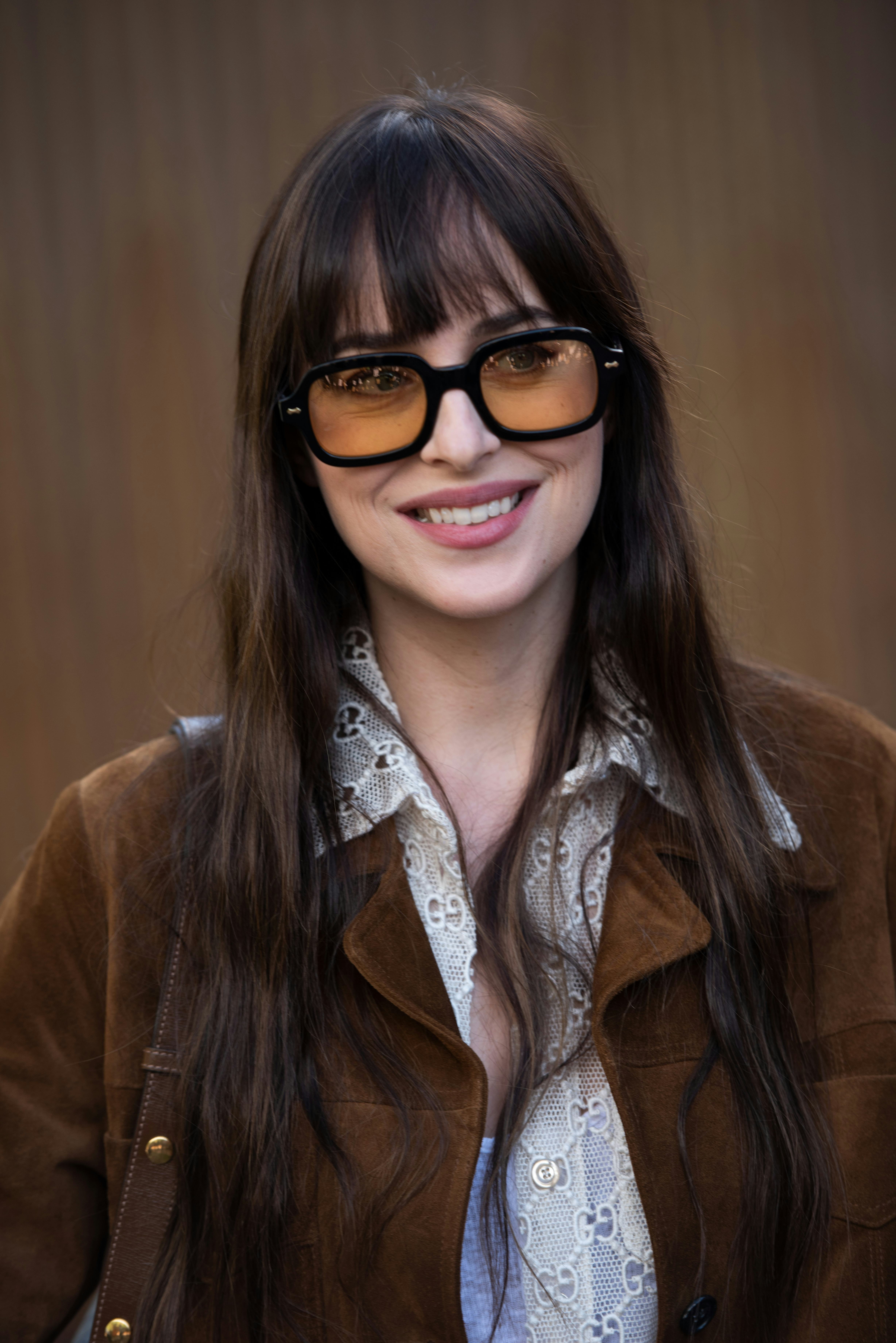 Dakota Johnson long 70s bangs and yellow glasses in Telluride